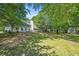 Scenic backyard with lush lawn, mature trees, and a storage shed at 3540 Pilgrim Mill Rd, Cumming, GA 30041