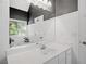 Bright bathroom featuring a bathtub, white vanity, and decorative mirror at 3540 Pilgrim Mill Rd, Cumming, GA 30041