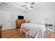 Bright bedroom with hardwood floors, white wainscotting, and tray ceiling at 3540 Pilgrim Mill Rd, Cumming, GA 30041