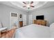 Spacious bedroom with tray ceilings, wood floors, and ensuite bathroom at 3540 Pilgrim Mill Rd, Cumming, GA 30041