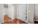 Welcoming foyer with light hardwood floors, white wainscotting, and a modern white door at 3540 Pilgrim Mill Rd, Cumming, GA 30041