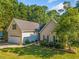Inviting home with well-manicured lawn and landscaping, complete with attached two-car garage at 3540 Pilgrim Mill Rd, Cumming, GA 30041