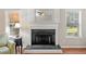 Bright living room featuring a white fireplace with decorative mirror and hardwood floors at 3540 Pilgrim Mill Rd, Cumming, GA 30041