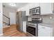 Modern kitchen with stainless steel appliances, white cabinets and granite countertops at 3540 Pilgrim Mill Rd, Cumming, GA 30041