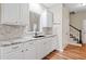 An elegant kitchen featuring granite countertops, white cabinets, and stainless steel appliances at 3540 Pilgrim Mill Rd, Cumming, GA 30041