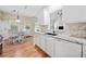 Charming kitchen with granite countertops, white cabinetry, and open dining area at 3540 Pilgrim Mill Rd, Cumming, GA 30041