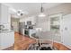 Bright kitchen featuring white cabinets, granite countertops, and a dining table at 3540 Pilgrim Mill Rd, Cumming, GA 30041