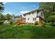 Expansive backyard featuring a wooden deck, lush green lawn, mature trees, and a home's exterior view at 626 Cheatham Sw Dr, Marietta, GA 30064