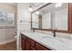 Bathroom features a double vanity with marble countertop and decorative light fixtures at 626 Cheatham Sw Dr, Marietta, GA 30064