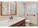 Bathroom featuring wood cabinet and trim, shower, and shutters at 626 Cheatham Sw Dr, Marietta, GA 30064