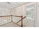 Carpeted hallway with wood banister, chandelier, and natural light at 626 Cheatham Sw Dr, Marietta, GA 30064