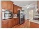 Modern kitchen featuring stainless steel appliances, cherry cabinets, granite counters, and hardwood floors at 626 Cheatham Sw Dr, Marietta, GA 30064