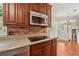 Kitchen features brick backsplash, granite counters, stainless steel microwave, and recessed lighting at 626 Cheatham Sw Dr, Marietta, GA 30064