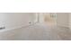 Bright, airy living room with plush carpeting, white trim, and large windows that flood the space with natural light at 626 Cheatham Sw Dr, Marietta, GA 30064