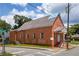 View of brick multi-Gathering home on corner lot with covered entry and some graffiti at 88 Martin Se Ave, Atlanta, GA 30315