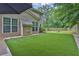 A fenced backyard featuring artificial turf, a patio, and an umbrella for outdoor relaxation at 1019 Avonley Creek Trce, Sugar Hill, GA 30518