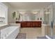 Spacious bathroom with double vanity, soaking tub, stand alone shower, and neutral tile flooring at 1019 Avonley Creek Trce, Sugar Hill, GA 30518
