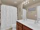 Bathroom featuring a double vanity and a shower tub with a white curtain at 1019 Avonley Creek Trce, Sugar Hill, GA 30518
