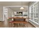 Bright breakfast nook with wood table, bench seating, and large windows, seamlessly connected to the living area at 1019 Avonley Creek Trce, Sugar Hill, GA 30518