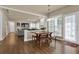 Bright breakfast nook with wooden table and bench seating, offering seamless access to both the living area and outdoor patio at 1019 Avonley Creek Trce, Sugar Hill, GA 30518