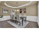 Refined dining room showcases a dark wood table, upholstered chairs, and wood flooring at 1019 Avonley Creek Trce, Sugar Hill, GA 30518