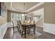 Elegant dining room features a tray ceiling, wainscoting, chandelier, and large windows at 1019 Avonley Creek Trce, Sugar Hill, GA 30518