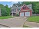 Lovely home featuring a long driveway leading to an attached garage and a well-maintained front lawn at 1019 Avonley Creek Trce, Sugar Hill, GA 30518