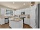 Well-lit kitchen features stainless steel appliances, granite countertops, and ample cabinet space at 1019 Avonley Creek Trce, Sugar Hill, GA 30518