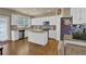 Bright kitchen with white cabinetry, granite countertops, stainless steel appliances, and a breakfast area at 1019 Avonley Creek Trce, Sugar Hill, GA 30518