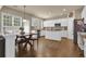 Open concept kitchen with white cabinetry, granite countertops, stainless steel appliances, and a breakfast area at 1019 Avonley Creek Trce, Sugar Hill, GA 30518