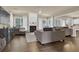 Comfortable living room with hardwood floors, fireplace, large windows, and abundant natural light at 1019 Avonley Creek Trce, Sugar Hill, GA 30518