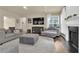 Spacious living room with fireplace, hardwood floors, and a comfy seating area for relaxation at 1019 Avonley Creek Trce, Sugar Hill, GA 30518