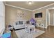 Cozy living room is shown with neutral colors, a sofa, table, TV, and play area at 1019 Avonley Creek Trce, Sugar Hill, GA 30518