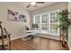 Home office featuring a large window, hardwood flooring, and a guitar rack at 1019 Avonley Creek Trce, Sugar Hill, GA 30518