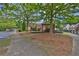 A covered park bench situated amongst mature trees, creating a tranquil place to relax at 1019 Avonley Creek Trce, Sugar Hill, GA 30518
