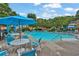 Community swimming pool with lounge chairs, tables, and umbrellas, offering a relaxing environment at 1019 Avonley Creek Trce, Sugar Hill, GA 30518
