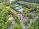 Community aerial view featuring pool, tennis courts, parking, greenspace, and lush landscaping at 214 Harmony Lake Dr, Canton, GA 30115