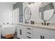 Luxurious bathroom with double sinks, white cabinets, soaking tub, and modern finishes at 214 Harmony Lake Dr, Canton, GA 30115