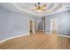 Spacious bedroom with a trey ceiling, ceiling fan and neutral paint, perfect for relaxation at 214 Harmony Lake Dr, Canton, GA 30115