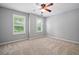 Bright bedroom with neutral carpet, ceiling fan, and large windows, perfect for relaxation at 214 Harmony Lake Dr, Canton, GA 30115
