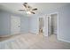 Spacious bedroom featuring a ceiling fan and neutral carpeting, offering comfort and style at 214 Harmony Lake Dr, Canton, GA 30115