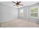 Bright bedroom with neutral carpet, ceiling fan, and large windows, perfect for relaxation at 214 Harmony Lake Dr, Canton, GA 30115