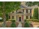 Charming brick home features manicured landscaping, covered entry, and an American flag for a welcoming curb appeal at 214 Harmony Lake Dr, Canton, GA 30115
