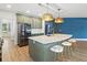 Spacious kitchen with a large island, stainless steel appliances, and stylish pendant lighting at 214 Harmony Lake Dr, Canton, GA 30115