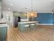 Open kitchen design featuring a large island with seating and modern stainless steel appliances at 214 Harmony Lake Dr, Canton, GA 30115