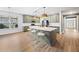 Spacious kitchen with a large island, modern appliances, stylish pendant lighting and a view of the entry at 214 Harmony Lake Dr, Canton, GA 30115