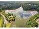 Scenic aerial view of a tranquil lake surrounded by lush greenery and wooded areas at 214 Harmony Lake Dr, Canton, GA 30115