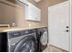Convenient laundry room with modern washer/dryer, counter space, and storage cabinets at 214 Harmony Lake Dr, Canton, GA 30115