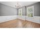 Empty living room featuring gray walls, two windows and hardwood floors at 214 Harmony Lake Dr, Canton, GA 30115