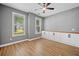 Empty living room featuring gray walls, two windows and hardwood floors at 214 Harmony Lake Dr, Canton, GA 30115